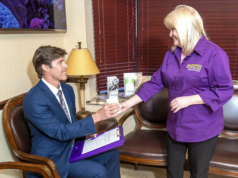 Person handing over a document.