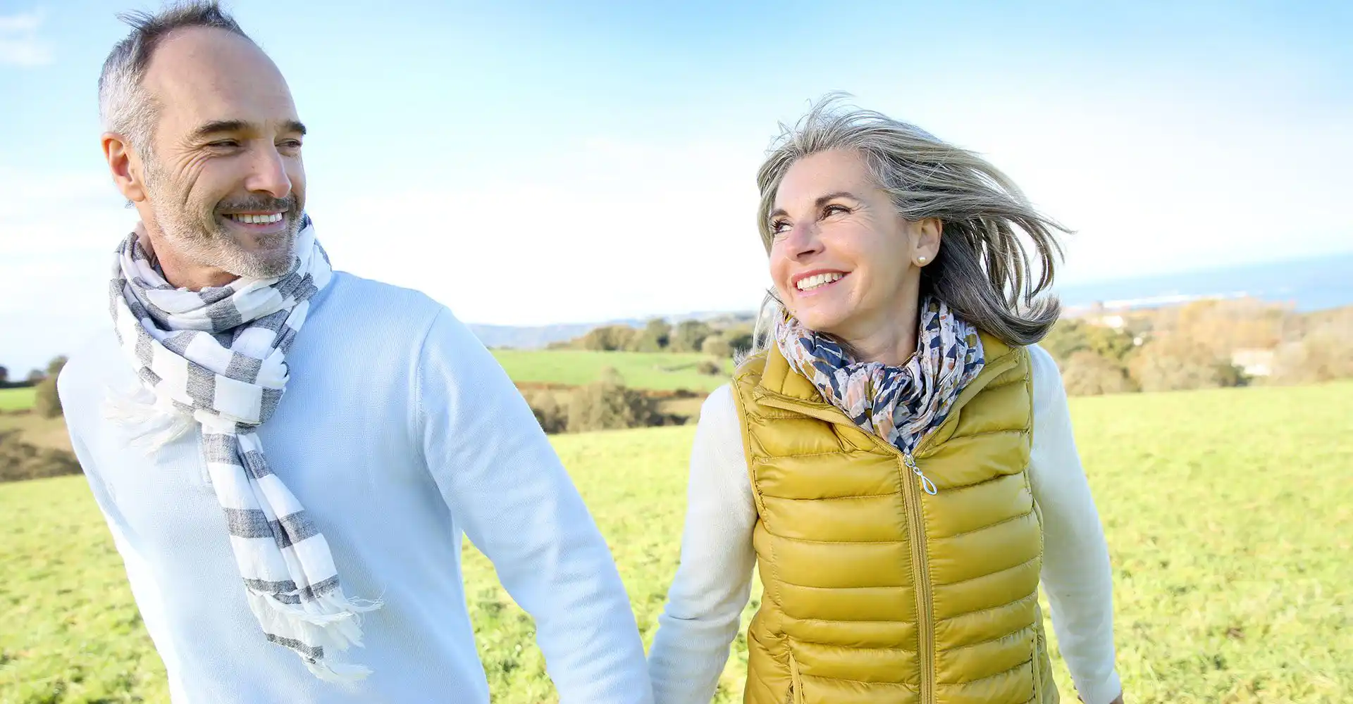 Image of a happy couple in a field.